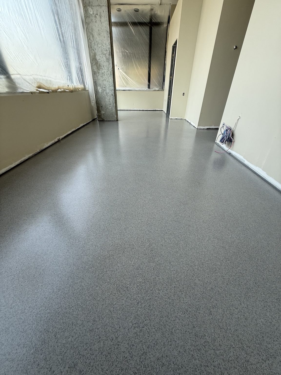 Wide view of the smooth decorative quartz floor installed by Western Canada Coatings in a Port Moody dental office.