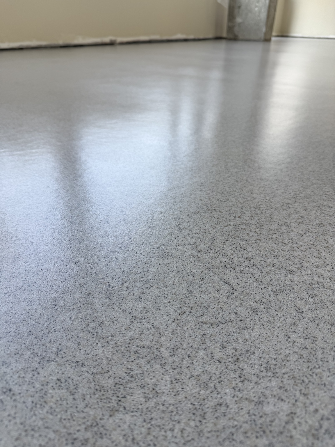 Low-angle detail of the smooth decorative quartz finish in the Port Moody dental office.